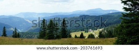 Landscape in the Black Forest; panoramic views over meadows and forests, mountains and valleys, in the background the Mountain Belchen/The Black Forest