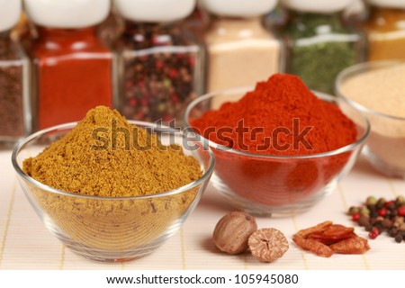 Various exotic spices in bowls. Selective focus on the curry powder.