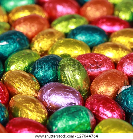 Group of colorful chocolate eggs forming a background