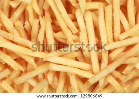 Fresh French fries forming a fast food background