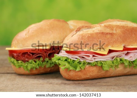 Sub Sandwiches with salami, ham, cheese, tomatoes and lettuce