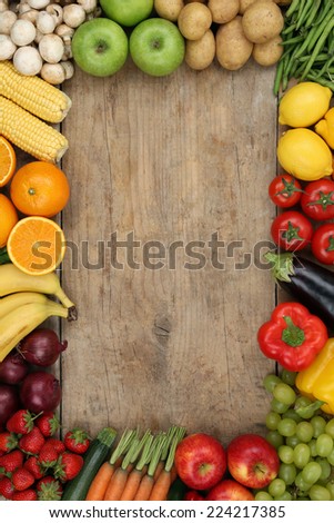 Healthy fruits and vegetables on wooden board with copyspace