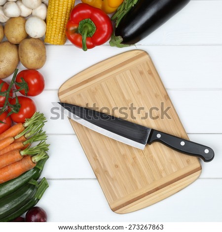 Healthy vegetarian cooking cutting board preparing food with knife and vegetables