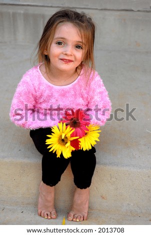 I picked these - A little girl showing off the flowers she picked.