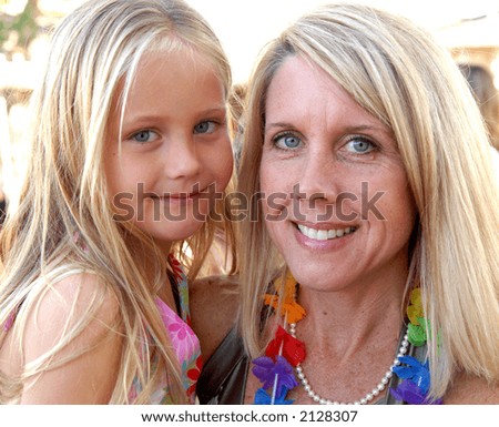 A mother and daughter posing together with great expressions on their  faces.
