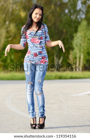 girl shows her slender figure walking in nature