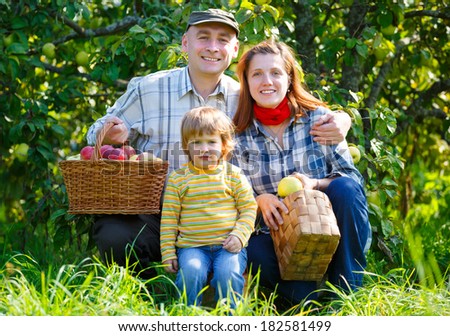 Happy Family in the garden harvest apples
