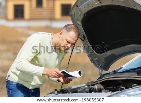 man  broken down car reading   user manual