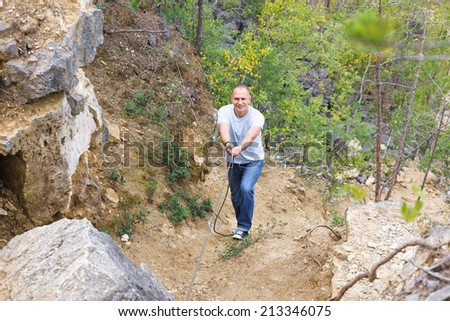 defocused man overcomes dangerous Wake up holding a rope