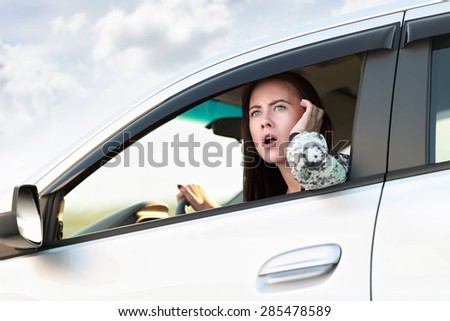 Displeased angry woman driving car. Negative human expression.