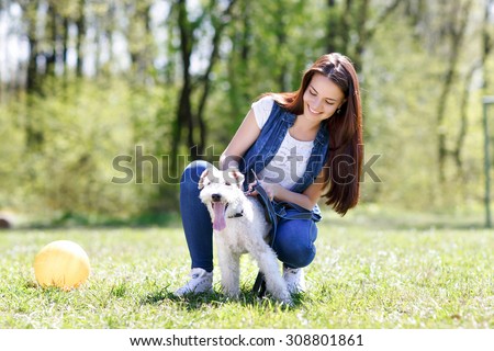 girl tie on a leash dog  in park