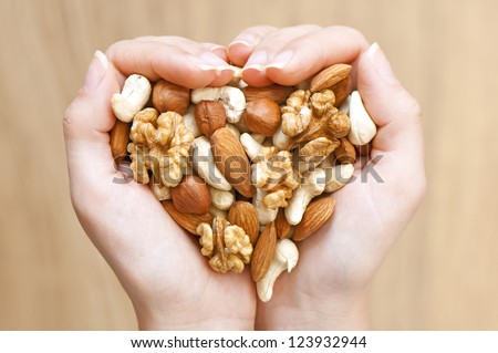 Various nuts in woman hands  forming heart shape Foto stock © 