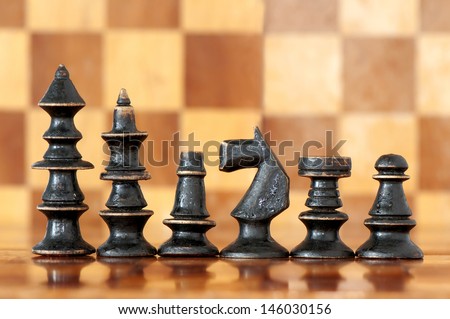 Chess black king with his suite on chess board background