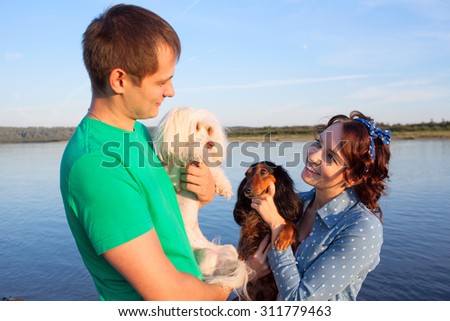 couple with their dogs on riverside, focus on girl\'s face