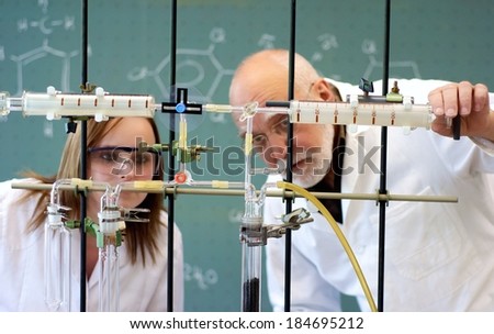 Student and professor experimenting with an apparatus