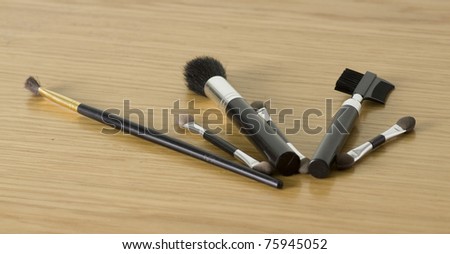 makeup tools isolated on a wooden background