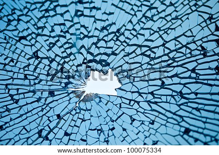 blue glass with many cracks and hole in middle