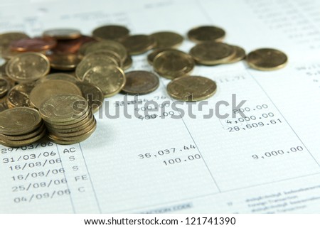 Bank saving account passbook with lot of coins