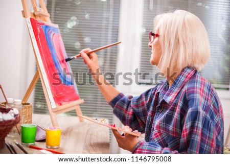 Similar – Image, Stock Photo Older woman painting on a notebook