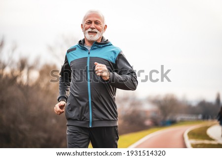 Active senior man is jogging. Healthy retirement lifestyle.