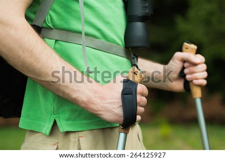 Close-up image of man hiker holding hiking poles