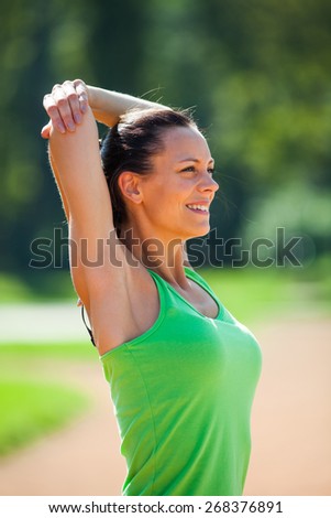 Happy woman stretching body, warming up for jogging