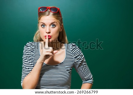 Young student girl in front of green blackboard