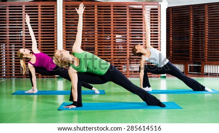Girls practicing yoga, Bikram triangle right