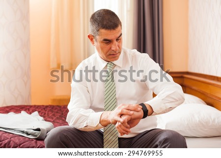 Businessman looking at his watch, he is ready for work