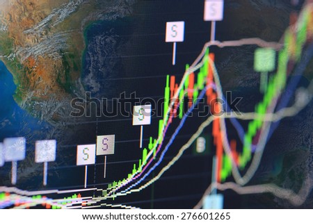 stock chart analysis on monitor,including elements furnished by NASA