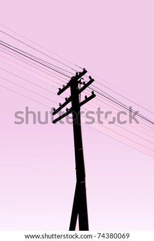 Old electric pillar and cable silhouette with purple sky,Thailand