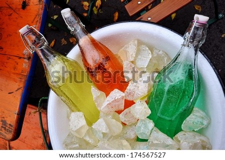 vintage soda pop bottles in a bucket of ice