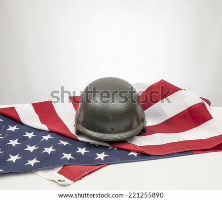 Military helmets and American flag on white background.