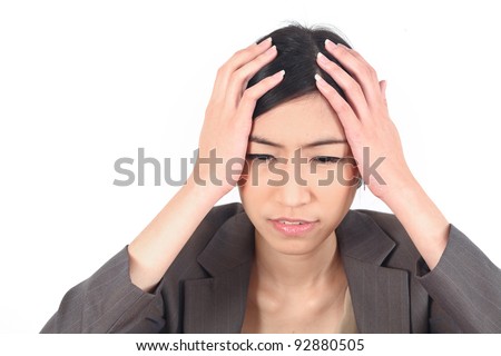 Business woman with bad headache holding head over white background