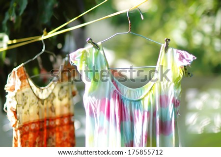 Two old dress hang on clothes line