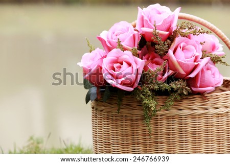 bouquet of pink roses in bamboo basket