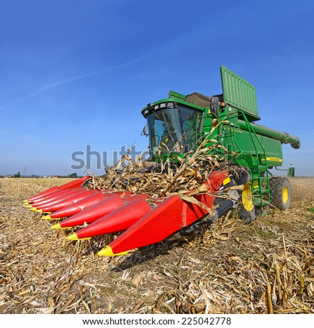 Kalush, Ukraine Ã¢Â?Â? OCTOBER 8: Modern John Deere combine harvesting corn  in the field near the town Kalush, Western Ukraine October 8, 2013