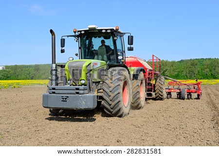 Kalush, Ukraine - May 10: Planting corn trailed planter in the field near the town of Kalush, Western Ukraine May 10, 2015