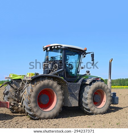 Kalush, Ukraine - May 10: Modern  tractor in the field near the town Kalush, Western Ukraine May 10, 2015