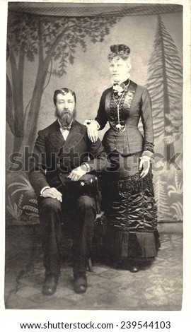 USA MASSACHUSETTS CIRCA 1875  A Vintage Carte De Visite photo of a couple. He is sitting in a chair and she is standing. Photo from the Victorian era. CIRCA 1875