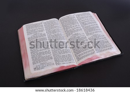 The Holy Bible, open to the book of Psalm\'s,  isolated on a black background