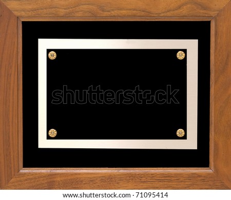A wooden frame with a metal plate which could hold information showing an award.