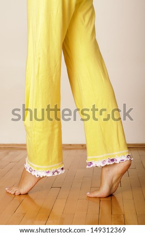 Barefoot Young Woman In Yellow Pajamas Stock Photo 149312369 : Shutterstock