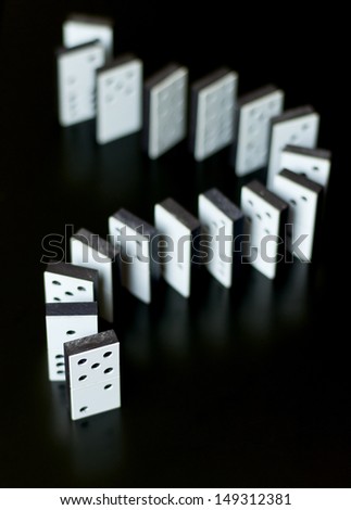 Dominoes on black reflective surface
