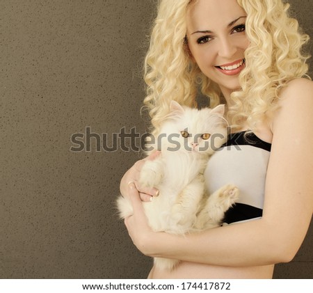 Pretty young woman holding adorable white Persian kitten