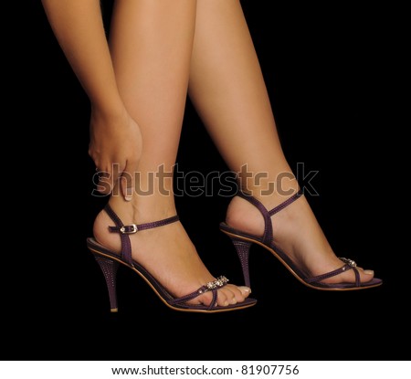 Woman rubbing her leg, pain from wearing high heels, stilettos, beautiful feet and sexy legs