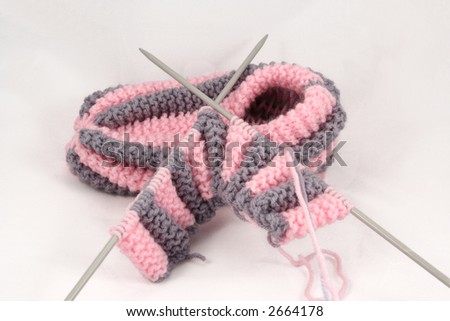 Knitted slipper and knitting-needles