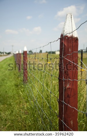 Rural fence made of steel wire and wooden post