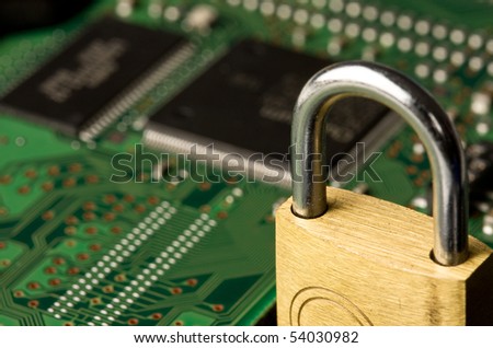 Close up of padlock on computer circuit board. Concept of network security.
