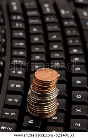 US coins on computer keyboard. Concept of e-commerce or online business.